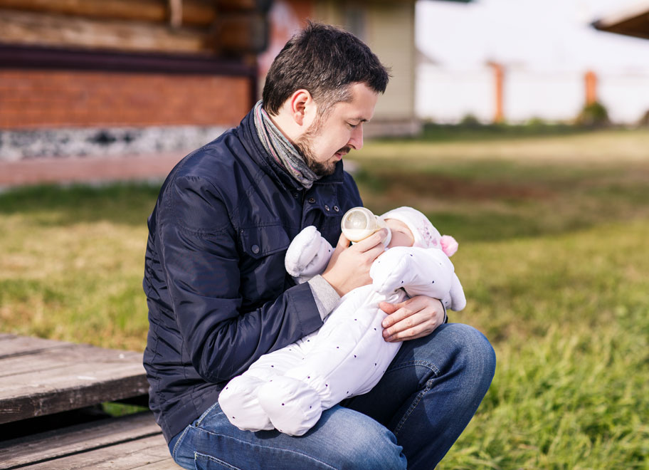 dad feeding baby in public