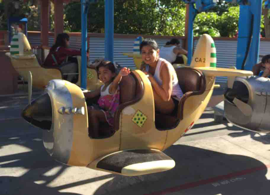 mom and daughter in a toy plane
